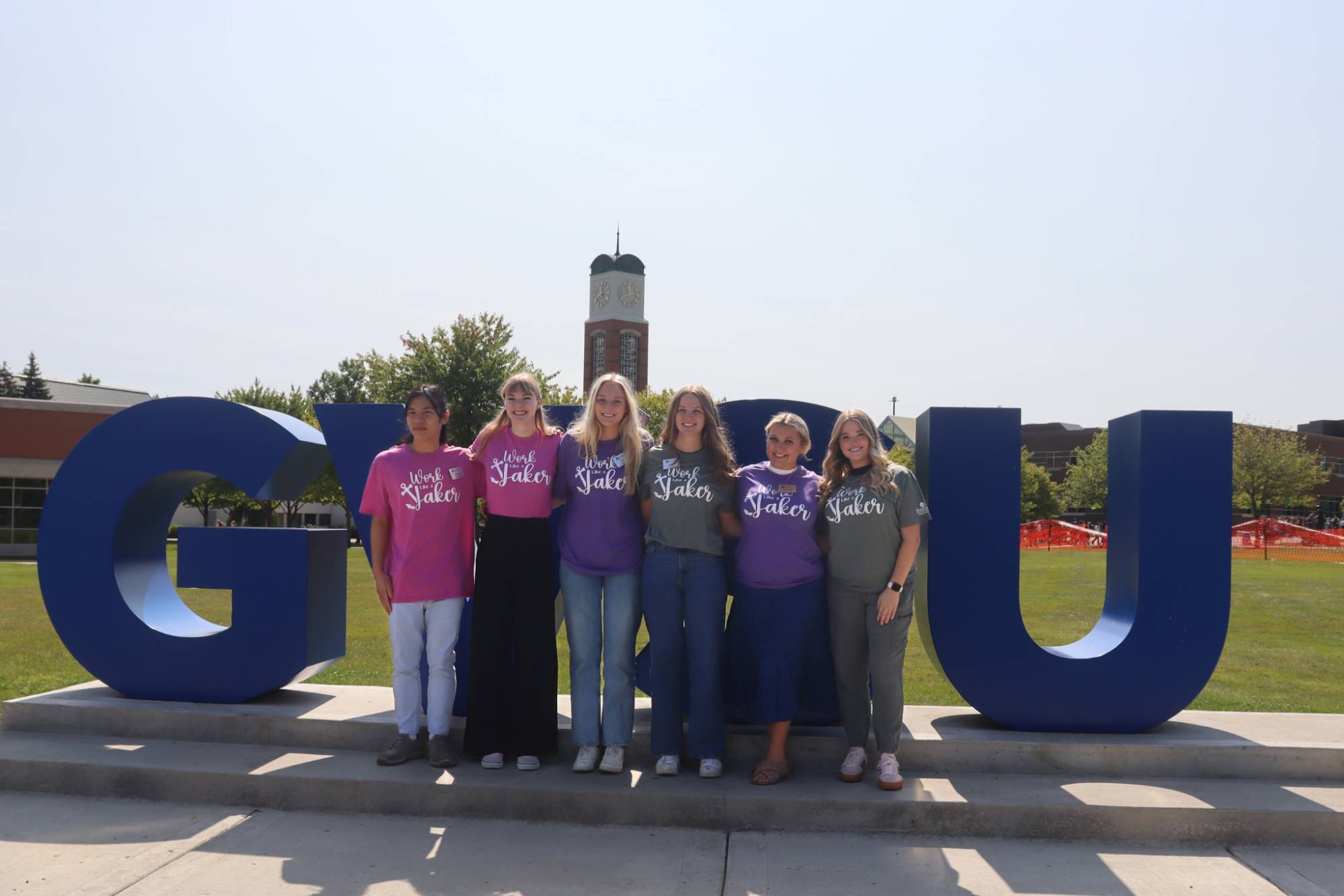 group of students in front of gvsu sign